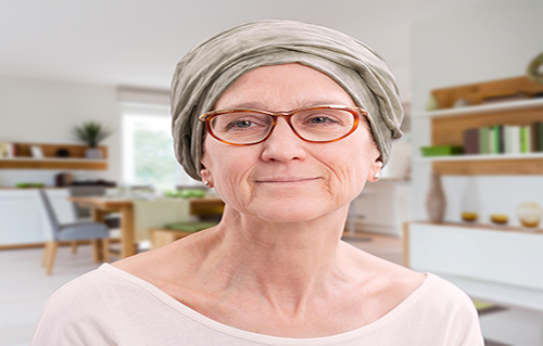 Seated patient wearing glasses and a headscarf